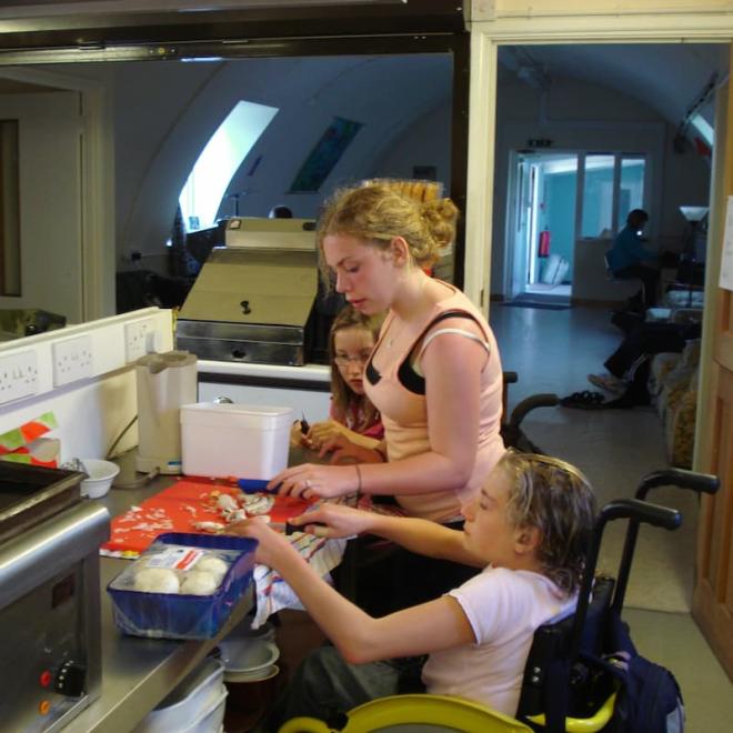 Heather cooking with two other Active8 members.