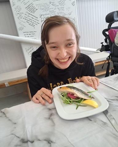 A photo of Amber proudly showing the Mackerel starter she prepared with the group. 