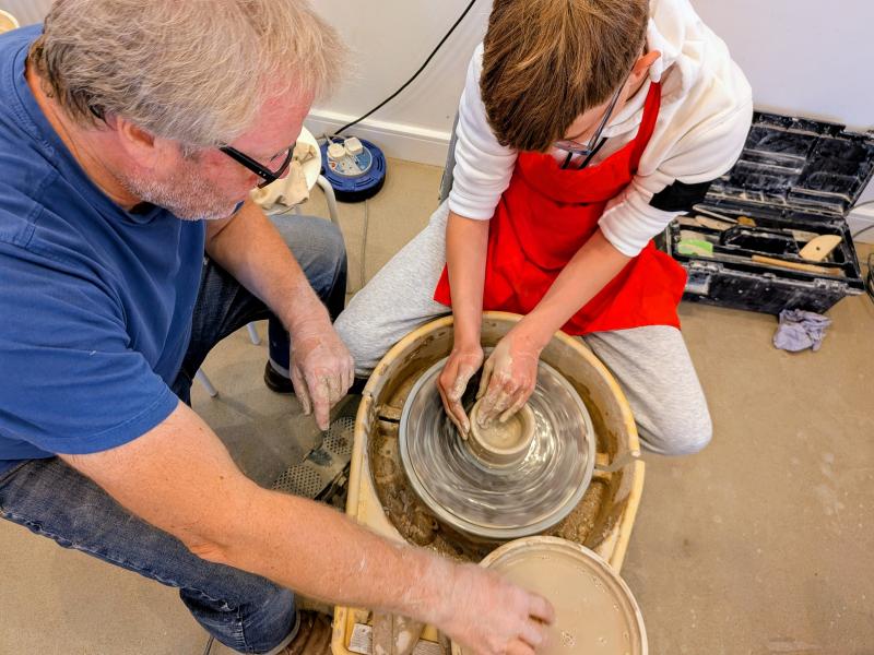 member using a pottery wheel